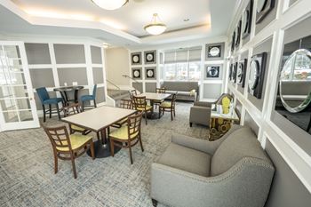 A room with a table and chairs in the middle of the room